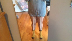 Shirt garters holding a blue plaid shirt down and connected to a pair of yellow socks.